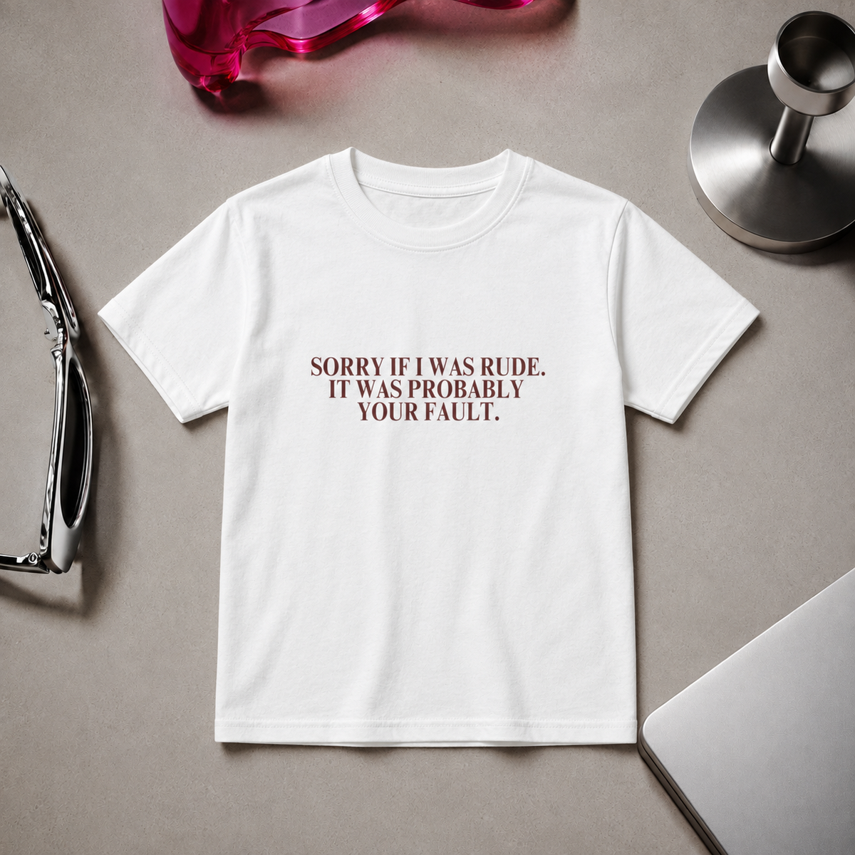 Woman wearing a fitted white “Sorry If I Was Rude, It Was Probably Your Fault” graphic T-shirt with black trousers