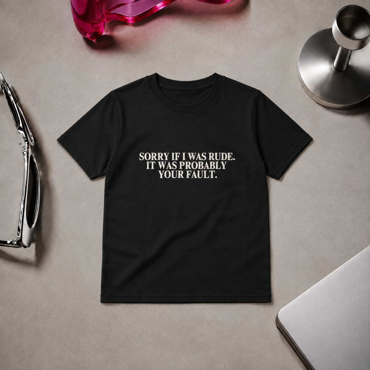 Woman wearing a fitted black “Sorry If I Was Rude, It Was Probably Your Fault” graphic T-shirt with black trousers