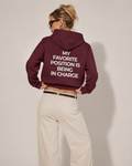 Burgundy feminist hoodie with cream My Favorite Position Is Being in Charge back print
