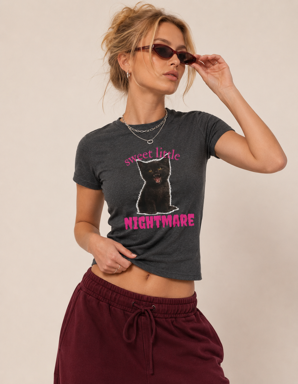 Close-up of the black kitten and pink Sweet Little Nightmare print on a fitted T-shirt