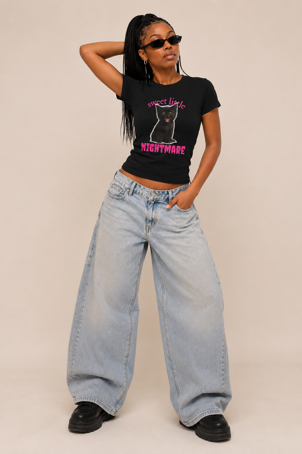 Woman wearing a fitted black cat graphic tee in a casual street-style photo