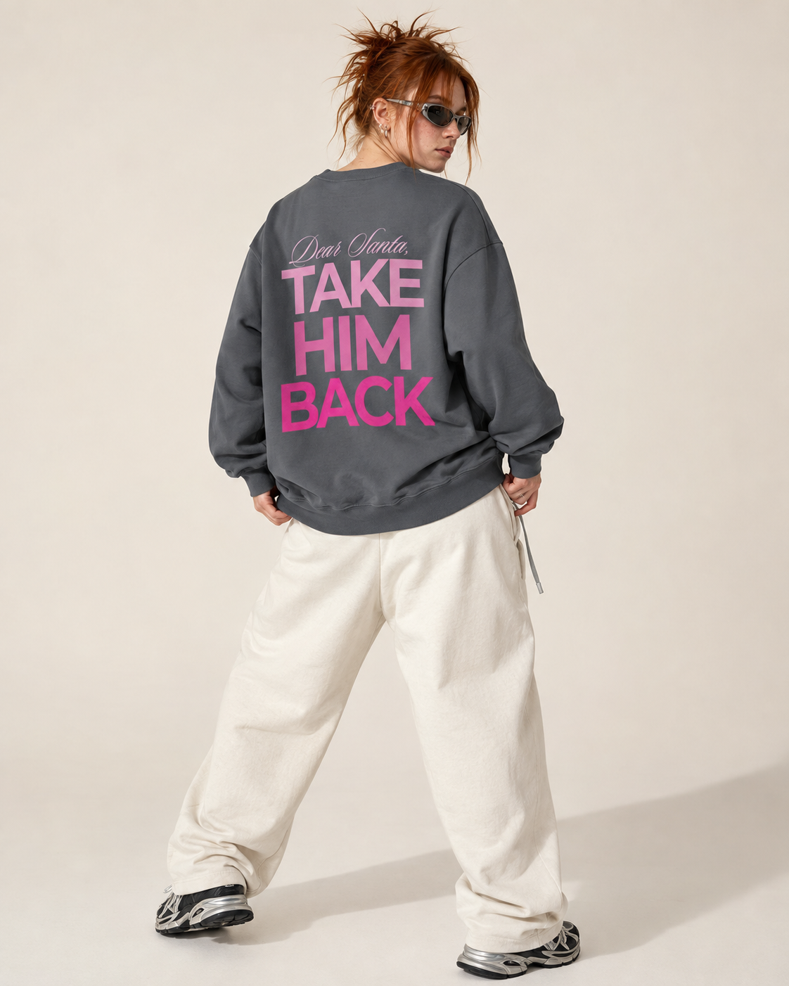 Back view of a charcoal Christmas sweatshirt with pink Take Him Back print