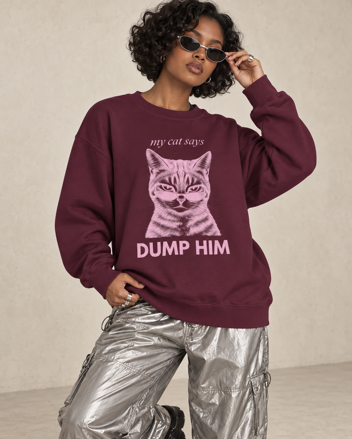 Model wearing a maroon My Cat Says Dump Him cat sweatshirt with silver cargo pants