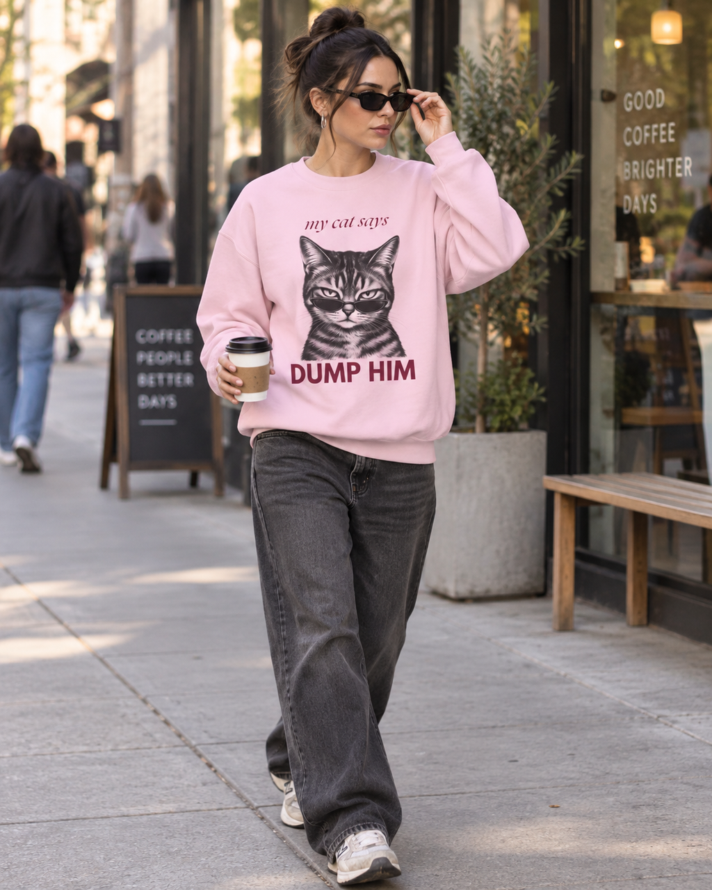 Street-style photo of a light pink My Cat Says Dump Him cat sweatshirt