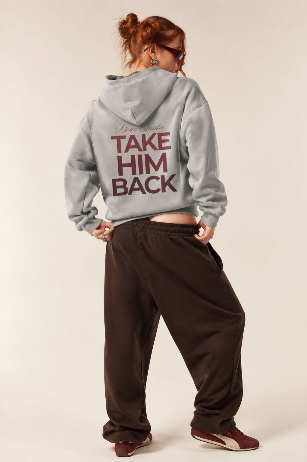 Model wearing a light gray Christmas breakup hoodie with brown baggy trousers