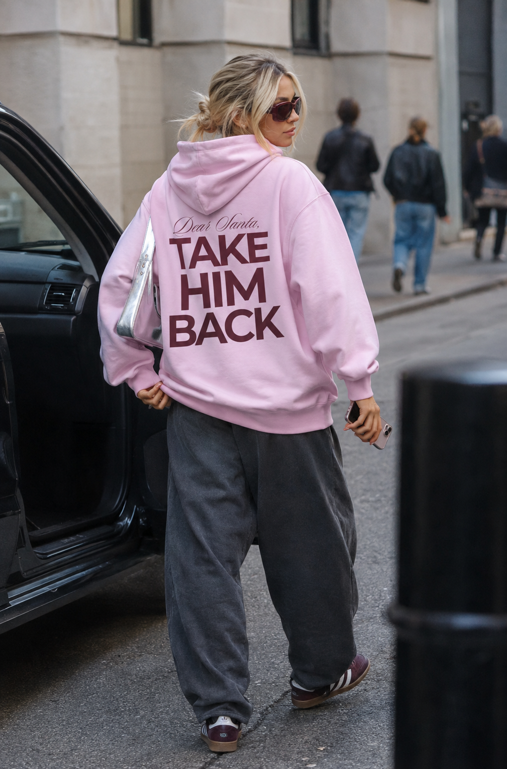 Street-style photo of a light pink Dear Santa Take Him Back hoodie